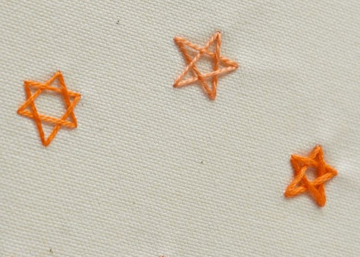 Estrellas contorneadas - Punto de estrella tejido con hilo naranja