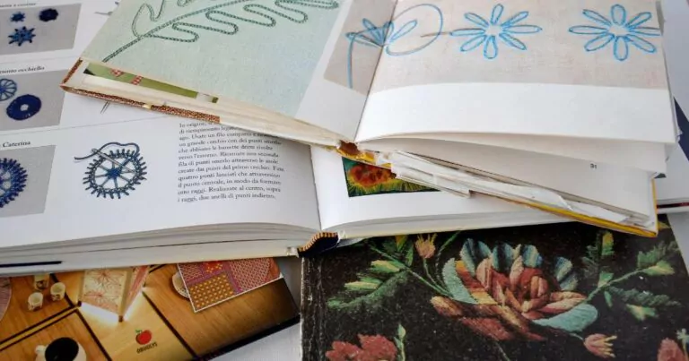 The pile of opened hand embroidery books 